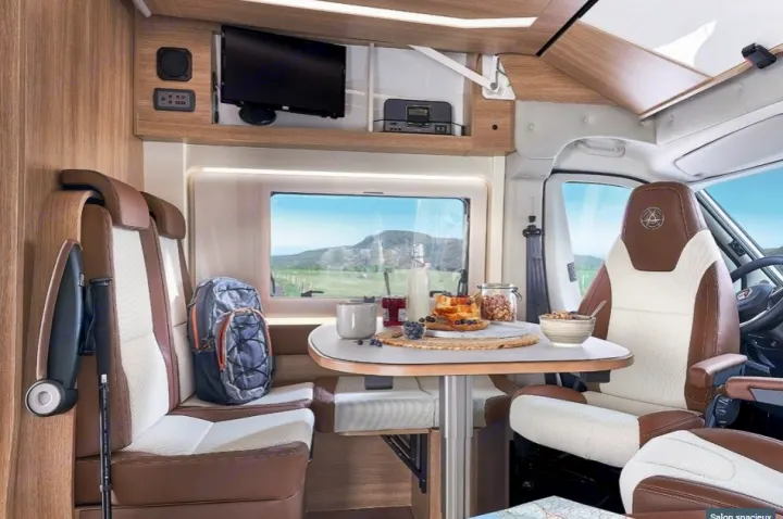 This RV rental offers a comfy lounge with a breakfast setup, TV, and breathtaking mountain views.. CAMPEREVE FAMILY VAN 2022