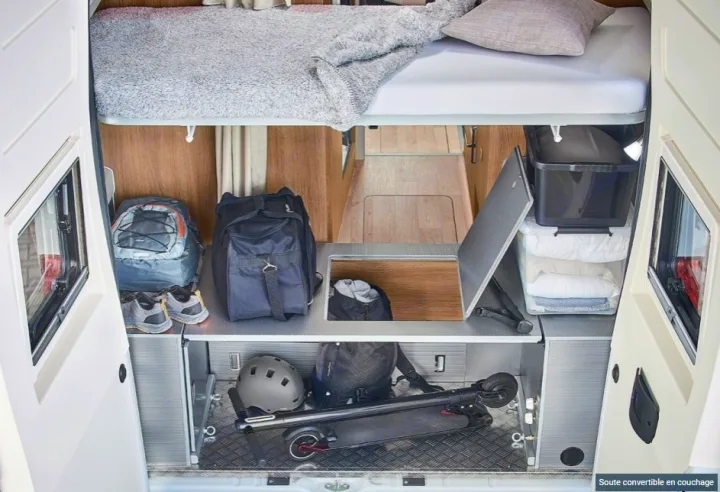 Efficient RV rental interior with bed and ample storage for gear like a scooter, bags, and supplies.. CAMPEREVE FAMILY VAN 2022
