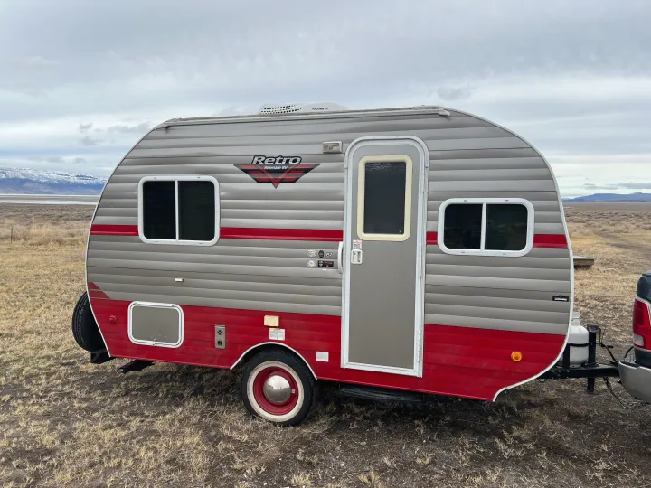 Retro Riverside RV travel trailer, perfect for an RV rental getaway. Parked in a vast, dry landscape.. Riverside Travel Trailer 157 Retro 2018