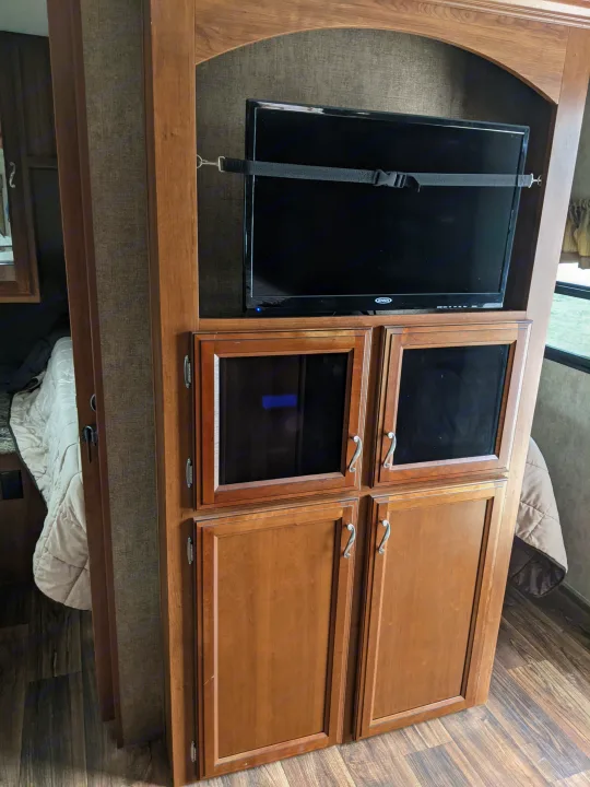 RV rental: Inside view of a functional entertainment unit featuring a secured TV and multiple storage cabinets.. Other Other 2015
