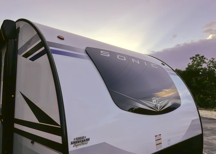Front view of a white Sonic travel trailer, an excellent RV rental option, under a soft twilight sky.. Venture Rv Sonic 2022