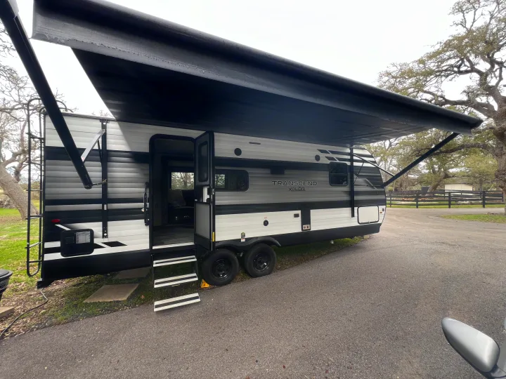 Experience camping in this spacious RV rental, a Transcend Xplor travel trailer with an extended awning, ready for your adventure.. Grand Design Transcend Xplor 2023