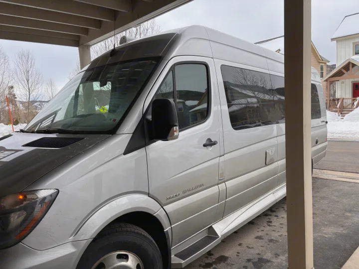 Explore this luxurious silver camper van, perfect as an RV rental for your winter road trip adventures.. Mercedes-Benz Sprinter RV Motorhome Campervan 2017