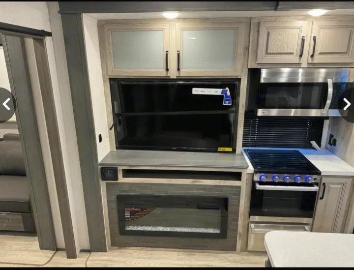 This RV rental offers a modern interior with a full kitchen (stove, microwave, cabinets), TV, and electric fireplace.. Keystone Alpine Avalanche 2024