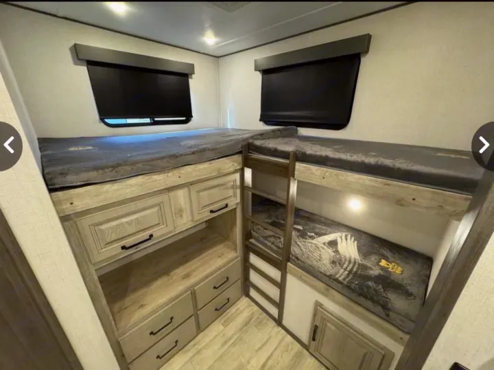 Spacious RV rental bunk beds with a ladder & built-in storage, designed for comfortable family adventures.. Keystone Alpine Avalanche 2024