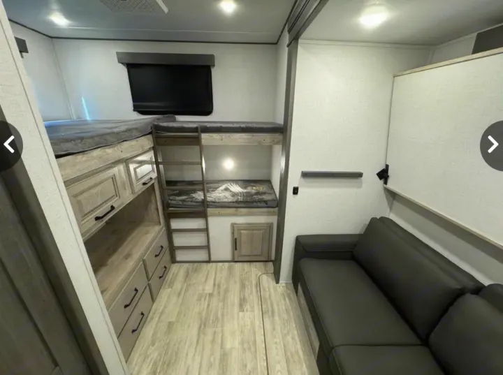 RV rental bunk room: A cozy interior with comfy bunk beds, storage, and a sofa for a relaxing family trip.. Keystone Alpine Avalanche 2024