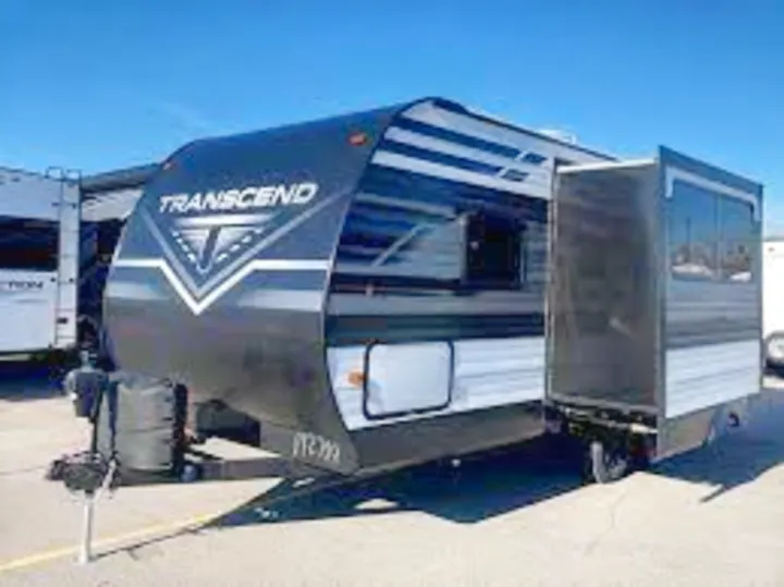 A sleek black and white Transcend travel trailer, featuring an extended slide-out, ready as an RV rental.. Grand Design Transcend Xplor 2021