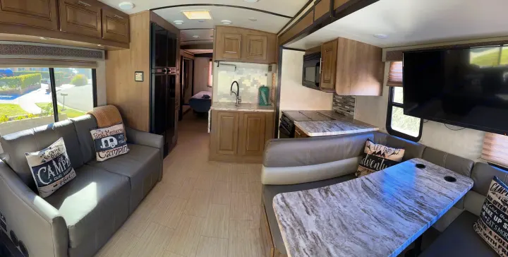 Explore this cozy rv rental interior: living room, full kitchen, dining area, and a peek into the bedroom.. FR3 FR3 Motorhome 2020