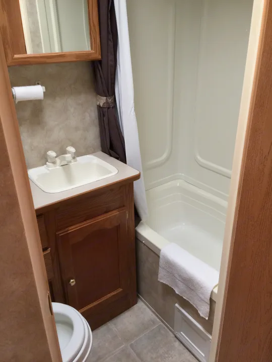 Well-equipped RV rental bathroom with sink, toilet, and shower/tub combo. Essential for comfortable travel.. Keystone RV Springdale 2005