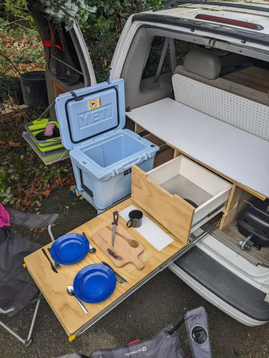 RV rental ready for outdoor cooking! Custom van setup with a pull-out kitchen, Yeti cooler, and camping gear.. Chevrolet Open Road 2002