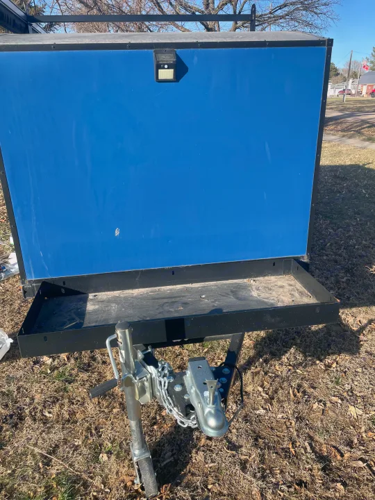 Small blue enclosed utility trailer for rv rental. Features a solar light, sturdy hitch, and cargo tray.. County Outbound Extreme 2021