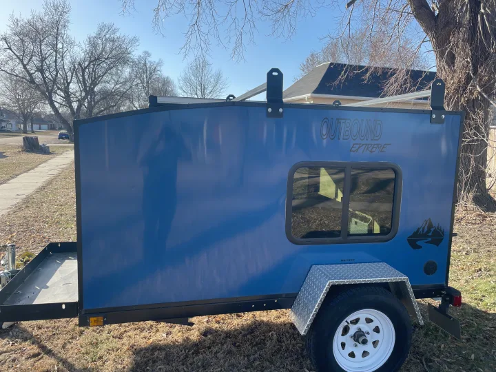 Blue Outbound Extreme teardrop trailer for rv rental, parked outdoors.. County Outbound Extreme 2021