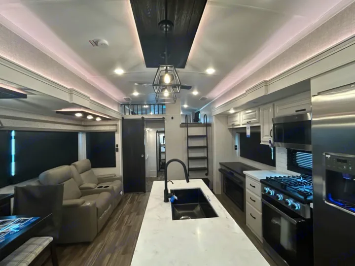 Luxury RV rental interior with a spacious kitchen, living area, and loft. Modern design for comfortable travel.. Keystone RV Jayco northpoint 2026