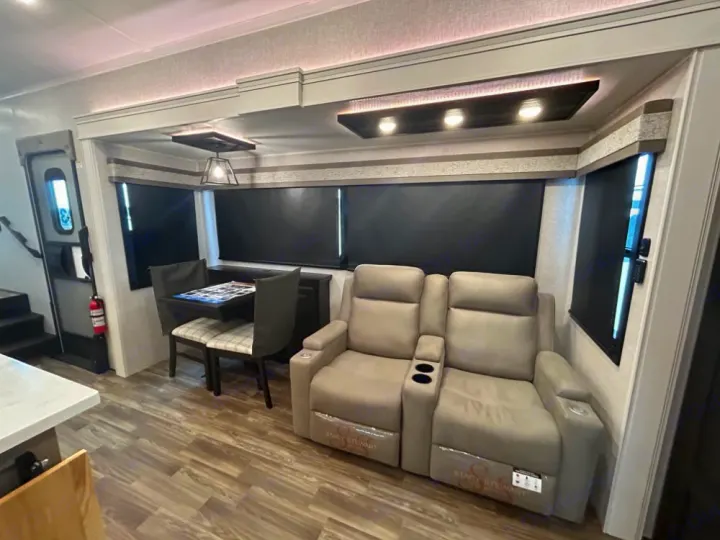 RV rental living area featuring comfortable recliners, a dining table, and windows with black-out blinds.. Keystone RV Jayco northpoint 2026