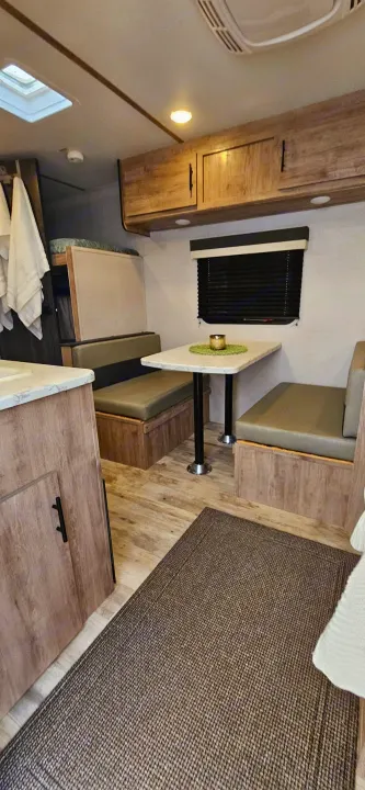 Step inside this modern rv rental, featuring a cozy dinette, overhead bunk, and kitchen area for your adventures.. Gulf Stream Ameri-Lite LE 2023