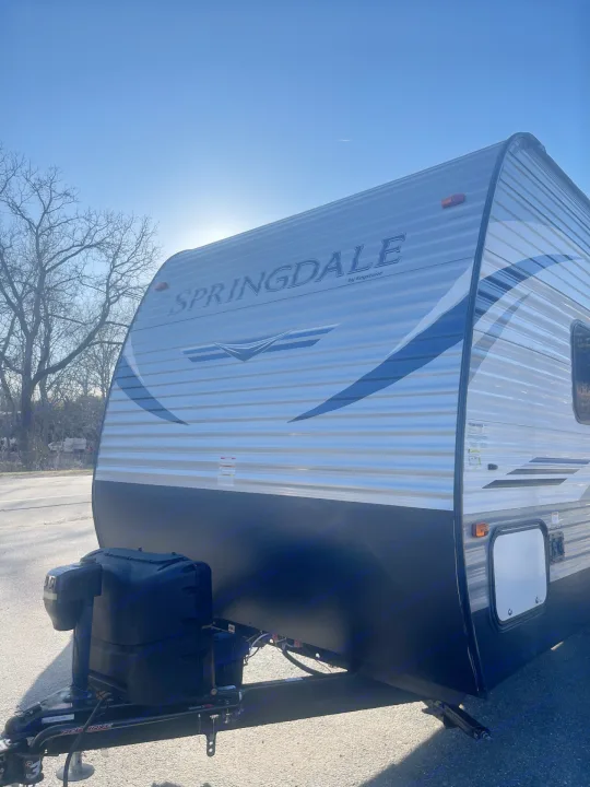 Silver Springdale by Keystone travel trailer, ideal for your next RV rental. Ready for adventure on a sunny day.. Keystone RV Springdale 2020