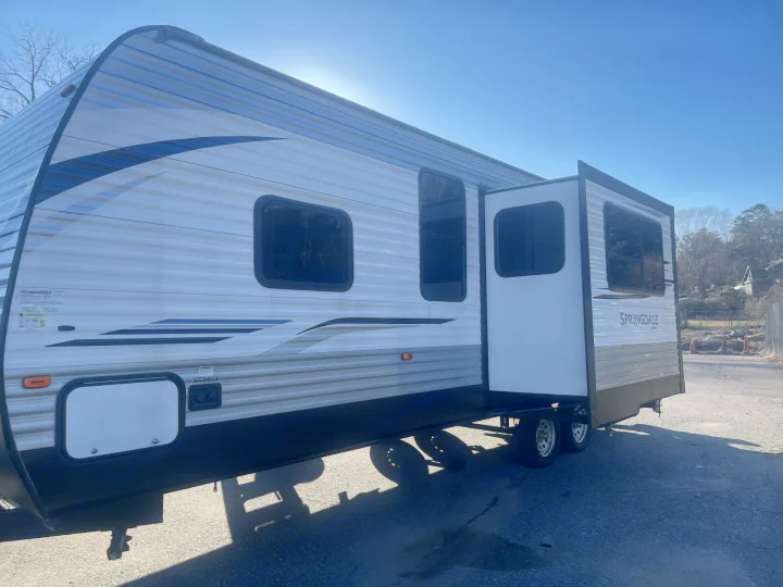 Sunny RV rental: a bright white Springdale travel trailer with an extended slide-out, ready for adventure.. Keystone RV Springdale 2020