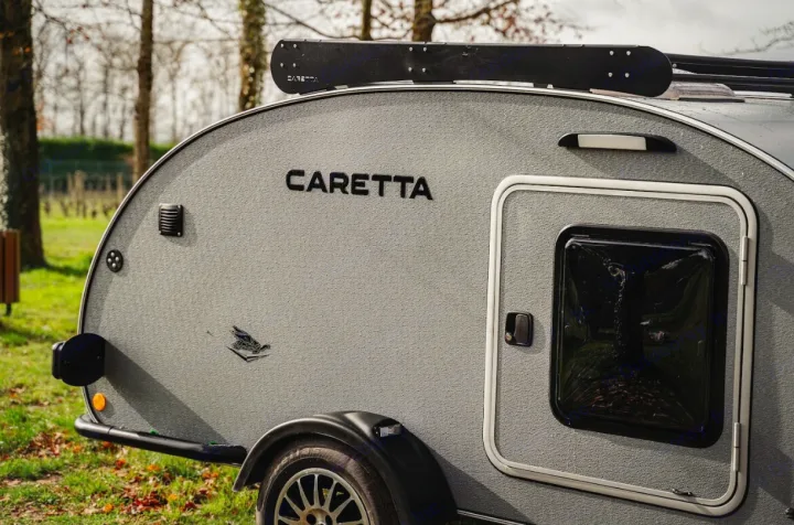 Close-up of a grey Caretta teardrop RV's rear. Ideal for your next RV rental adventure, compact and ready for the outdoors.. Caretta 1500 2024
