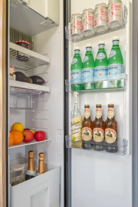 This RV rental fridge is packed with San Pellegrino, Birra Moretti, elderflower cordial, fresh fruit, and other snacks.. GlamperRV DBM Automatic 2025