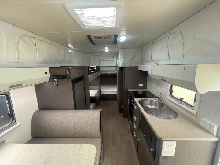 Inside an RV rental: full kitchen, cozy dining booth, and rear bunk beds, perfect for family travel.. Jayco 17.56-2.OB.MY18 2018