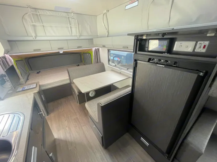 RV rental interior features a comfortable bed, dinette with table, kitchen sink, and Dometic fridge.. Jayco 17.56-2.OB.MY18 2018