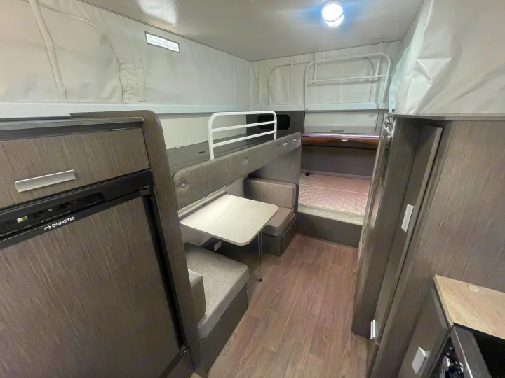 Explore this versatile RV rental featuring a cozy dinette, bunk beds, and a compact Dometic refrigerator.. Jayco 17.56-2.OB.MY18 2018