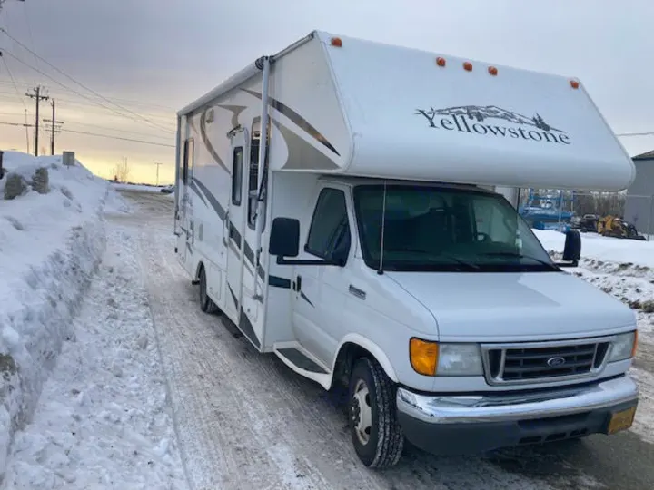 White Yellowstone RV rental parked on a snow-covered road, ideal for winter adventures.. Yellowstone Conquest M6254 2008