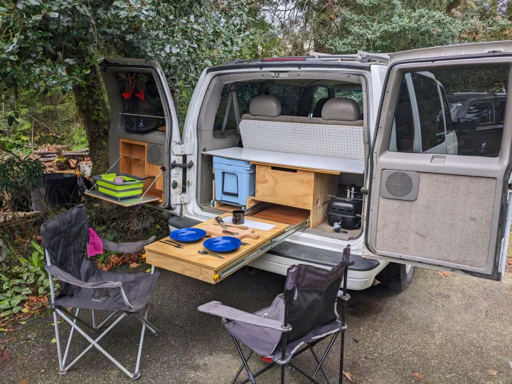 Van life rv rental: rear reveals a pull-out kitchen, cooler, and chairs for outdoor dining.. Chevrolet Open Road 2002