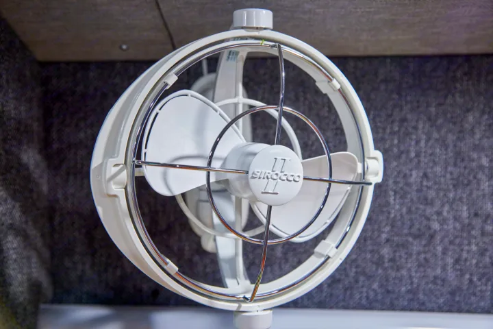 Close-up of a white Sirocco II fan, a popular feature in RV rentals, providing cool air for comfortable journeys.. Gmc sierra 1500 2024