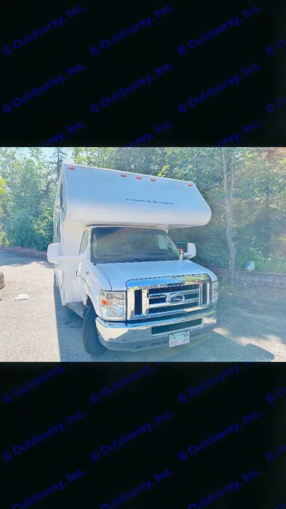 A white Winnebago Class C motorhome RV rental, perfect for travel. Parked on a sunny day.. Winnebago Chalet 2010