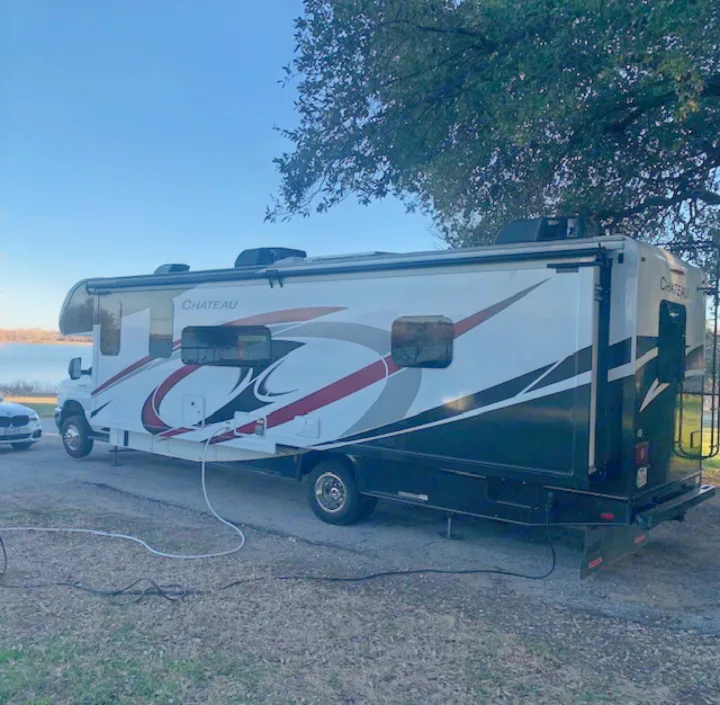 This large Chateau **RV rental**, parked lakeside with hookups, offers a perfect escape for outdoor enthusiasts.. Thor Chateau 2021