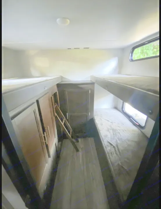 RV rental bunkhouse: features two sets of bunk beds, a ladder, and storage cabinets, ideal for family travel.. Forest River Cherokee Grey Wolf 2019
