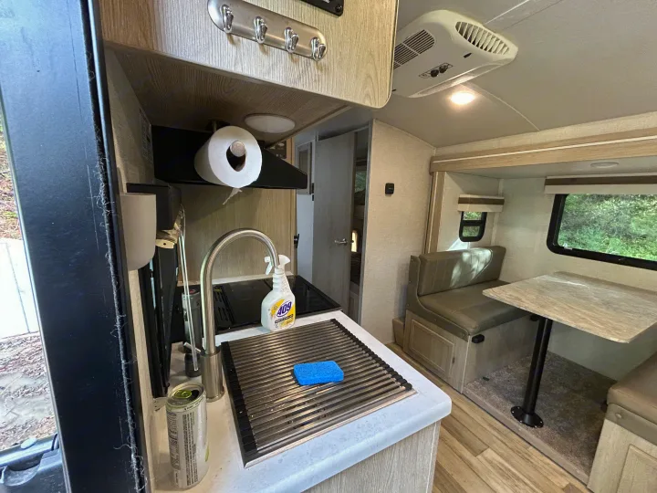 RV rental: well-equipped kitchen and dining booth with views of lush greenery through the window.. Geo pro Geo pro by rockwood 2022