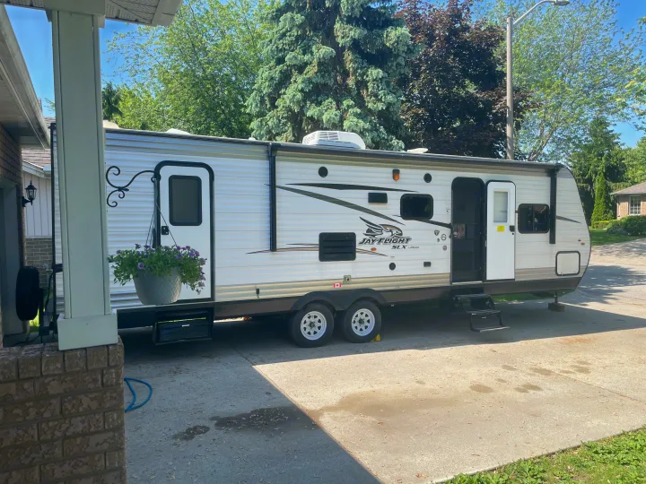 Spacious RV rental, a Jayco travel trailer, parked on a driveway with steps extended, ready for adventure or a comfortable home base.. Jayco Jay Flight SLX 2017