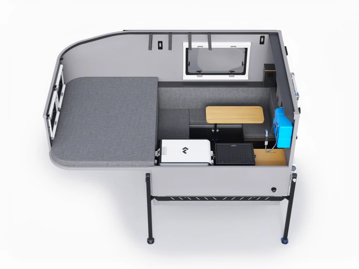 Overhead view of a compact RV rental interior, showing a grey bed, dinette, and portable kitchen setup.. Dodge Dodge Bighorn 3500 Heavy Duty Pu 2005