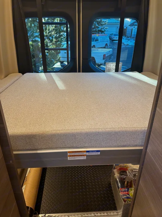 RV rental interior features a cozy bunk bed with under-bed storage, including a diamond plate floor for gear.. Mercedes-Benz Entegra Launch 2024
