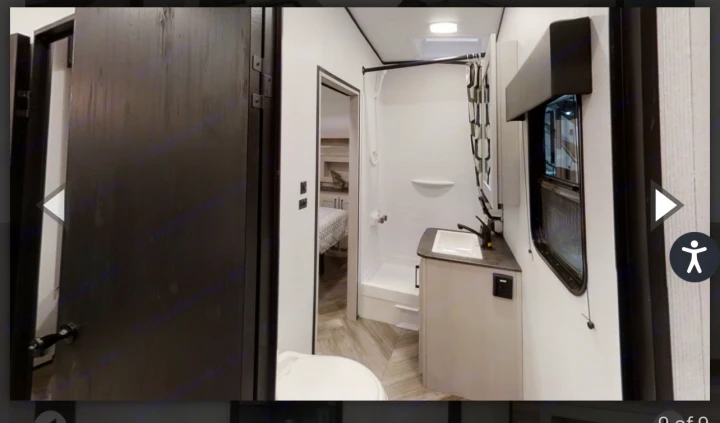 Modern RV rental bathroom featuring a shower, sink, toilet, and glimpse of the adjacent bedroom. Clean interior.. Heartland Torque 2022