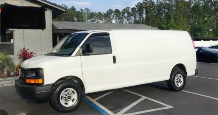 White cargo van, likely GMC Savana, parked in a lot. Explore this vehicle for rental or an RV rental project.. Gmc Savanna 2013