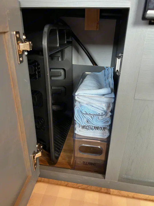 Organized RV rental cabinet: vertical dish rack, clear bins for miscellaneous microfiber cloths and cleaning supplies.. Keystone Bullet Crossfire 4YDTBLN25RD430760 2024