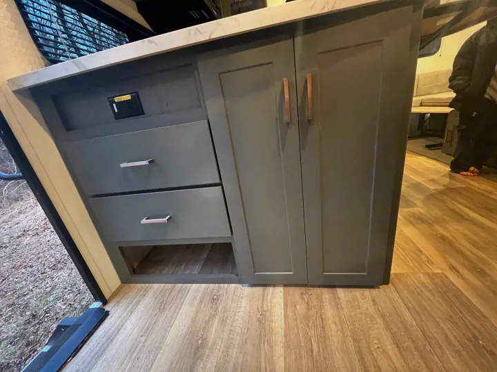 Modern RV rental interior: Sleek gray cabinets & wood-look floor, providing comfortable living space.. Keystone Bullet Crossfire 4YDTBLN25RD430760 2024