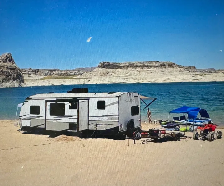 RV rental travel trailer camping by the lake with watercraft & ATV on a sandy beach.. Twilight RVS Signature 2022