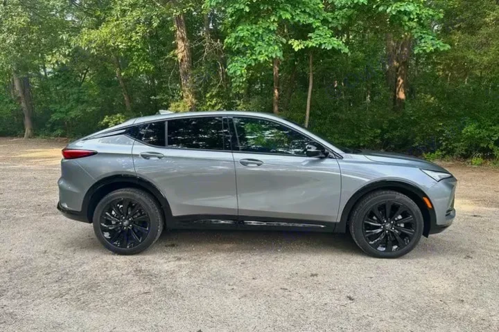 This sleek gray SUV, while not an RV rental, offers a stylish option for scenic drives through wooded areas.. Buick Envista 2024