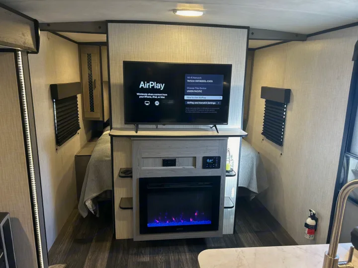 Modern rv rental features a Vizio smart TV with AirPlay, an electric fireplace, and beds on both sides for comfort.. Heartland RVs Mallard 2021