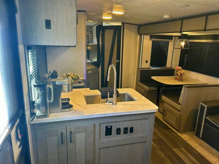 This RV rental's inviting interior features a well-equipped kitchen and comfortable dinette.. Heartland RVs Mallard 2021