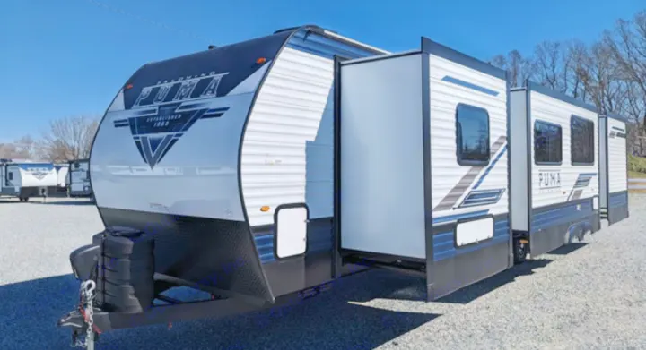 This new white and black Puma travel trailer RV, with its slide-out extended, is ready for your next rv rental adventure.. Forest River Palomino Puma 2022