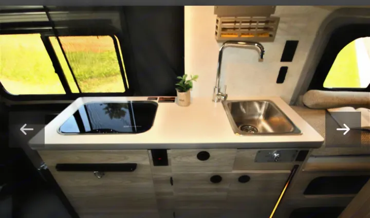 Spacious RV rental kitchen with sink, induction cooktop, and ample storage, perfect for your next adventure.. Winnebago Solis 2023