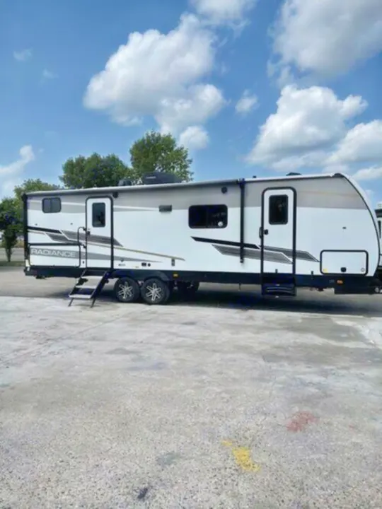 Modern white & grey travel trailer with steps, perfect for an rv rental & family camping adventures.. Cruiser Rv Corp Radiance 2022