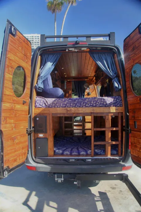 This RV rental offers a custom wood interior with bunk beds, perfect for a cozy van conversion adventure.. Mercedes-Benz Sprinter 2016