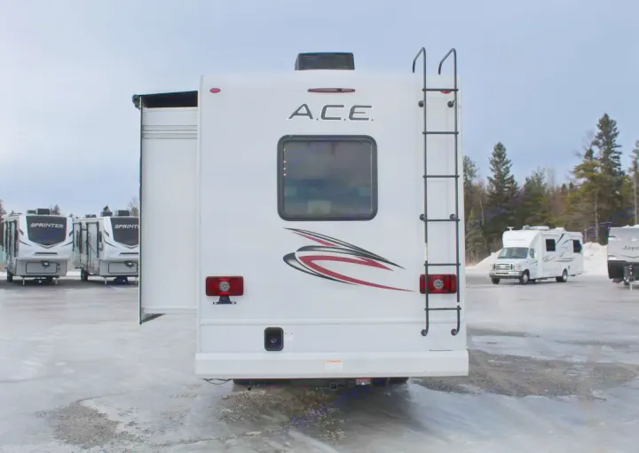 Rear view of an A.C.E. Class C motorhome, perfect for rv rental. Slide-out extended on an icy outdoor lot.. Thor Motor Coach ACE 29D 2023