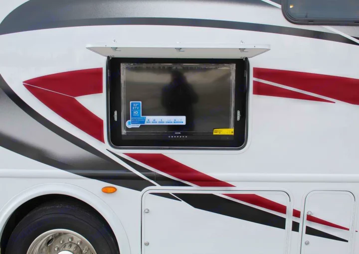 An RV rental features a 32" HD outdoor TV, perfect for open-air entertainment during your travels.. Thor Motor Coach ACE 29D 2023